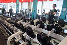 image of a weight room with a person lifting weights